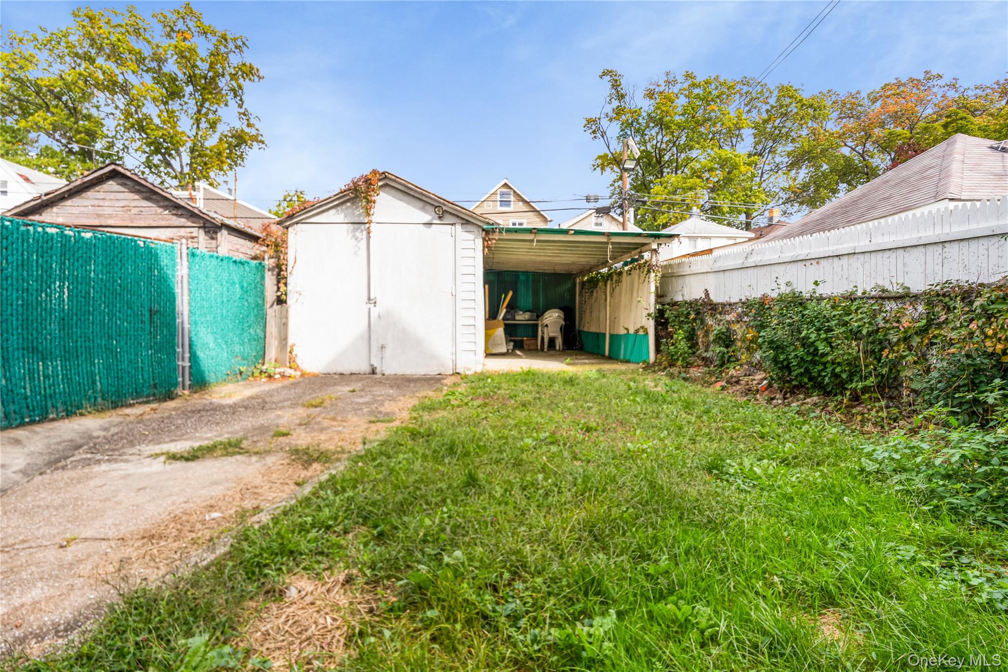 104-37 125th Street Queens, NY 11419 - Photo 23 of 24 a view of a house with a small yard and a garden