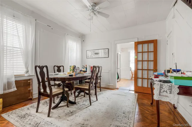 a view of a dining room and livingroom with furniture window and wooden floor