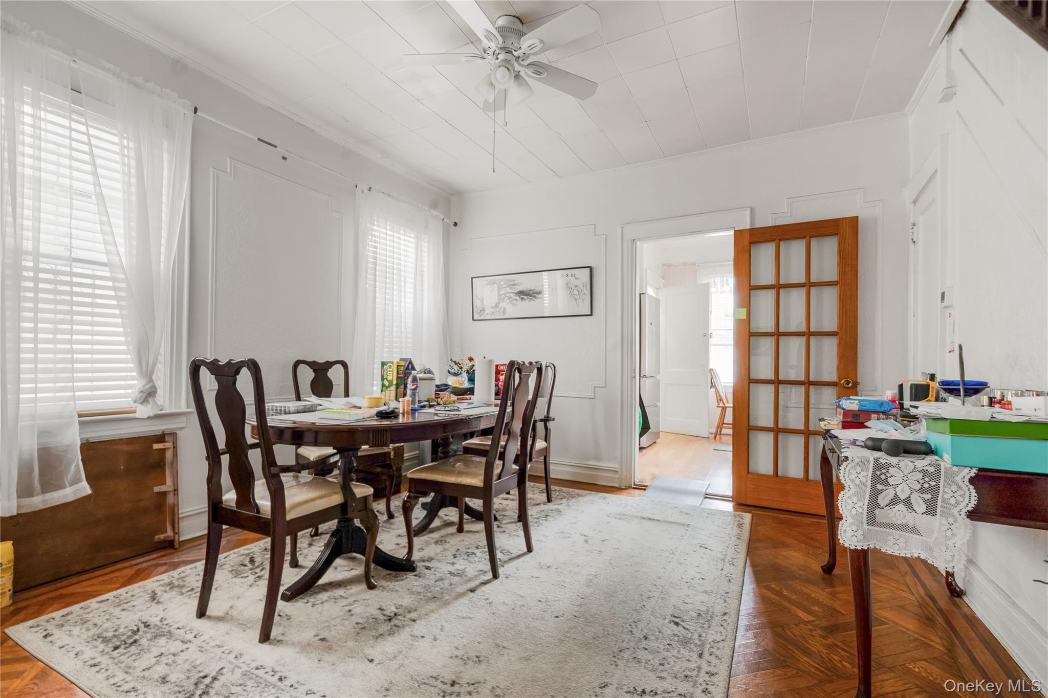 104-37 125th Street Queens, NY 11419 - Photo 7 of 24 a view of a dining room and livingroom with furniture window and wooden floor