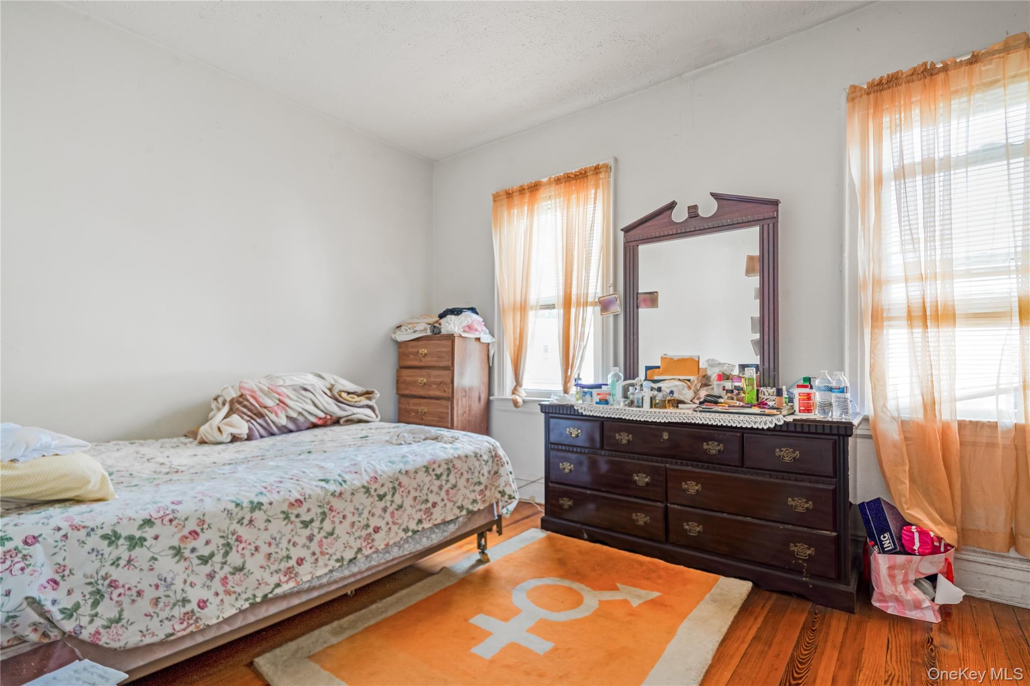 104-37 125th Street Queens, NY 11419 - Photo 10 of 24 a bedroom with a bed and a dresser