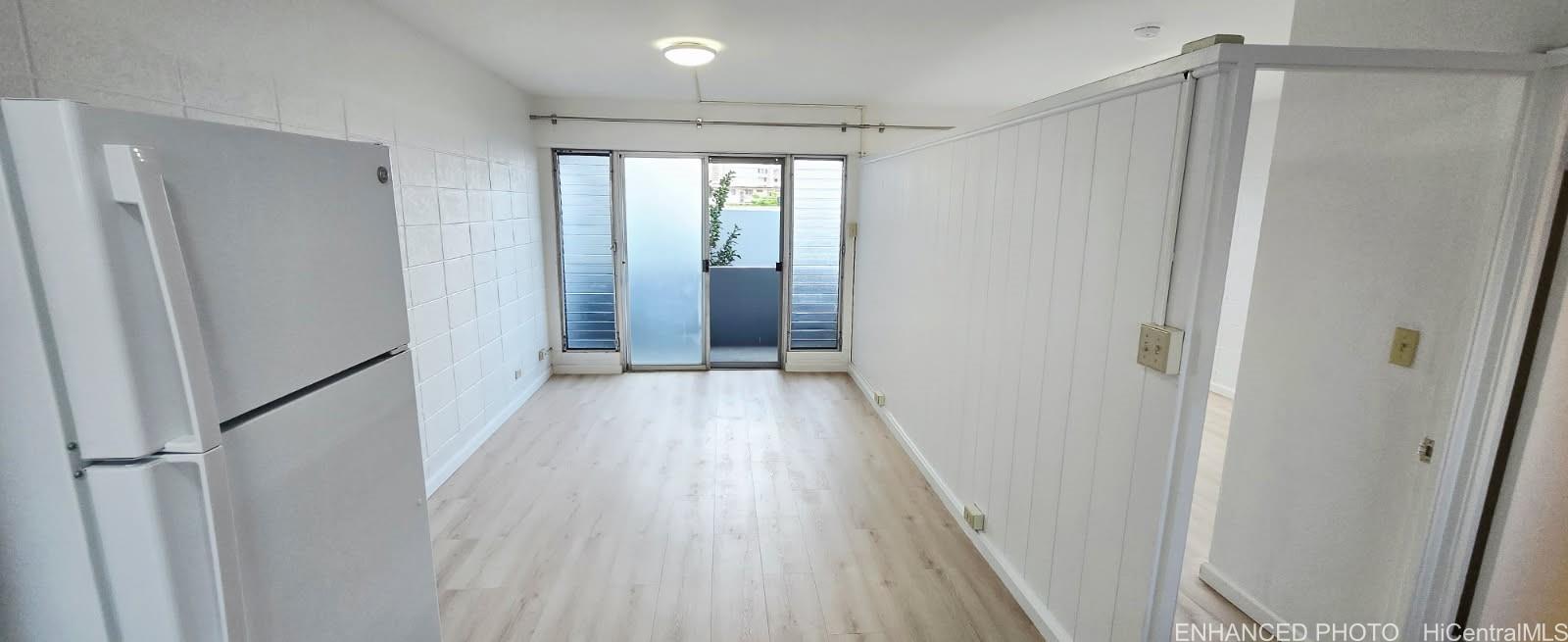 909 University Avenue, Unit 214 Honolulu, HI 96826 - Photo 2 of 13 a view of a hallway with wooden floor and staircase