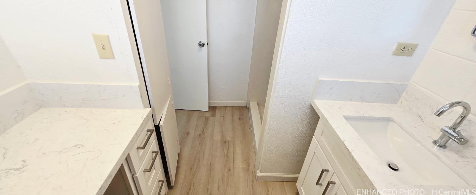 909 University Avenue, Unit 214 Honolulu, HI 96826 - Photo 7 of 13 a bathroom with a sink a mirror and shower
