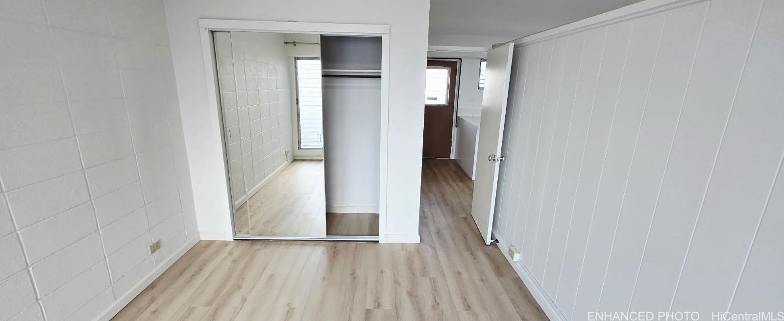 909 University Avenue, Unit 214 Honolulu, HI 96826 - Photo 10 of 13 a view of a hallway with wooden floor and staircase