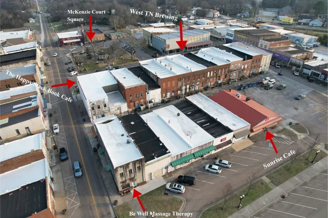 an aerial view of a swimming pool with outdoor seating