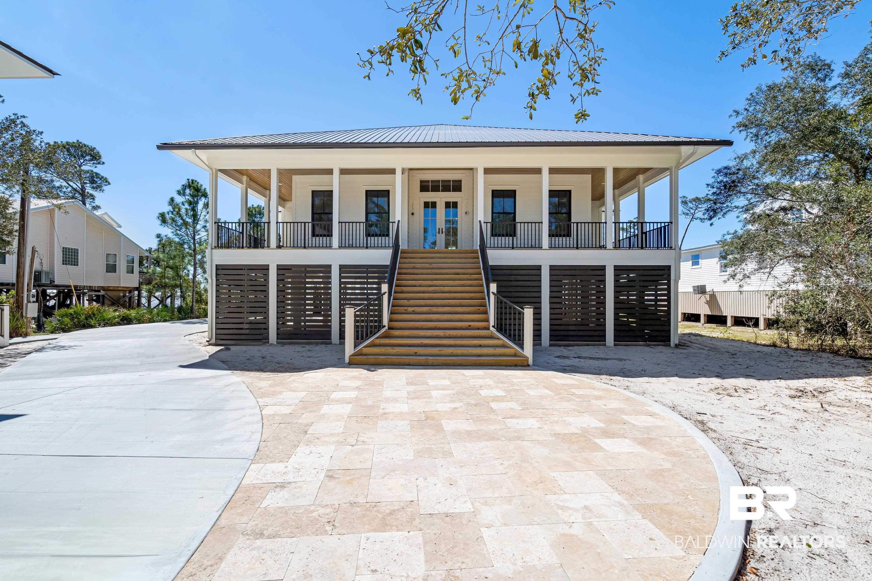 14686 State Highway Gulf Shores, AL 36542 - Photo 26 of 44 Coastal home featuring stairway, metal roof, french doors, and a porch