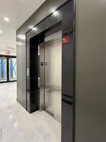 a kitchen with granite countertop a refrigerator a stove a microwave and island