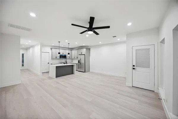 a view of a kitchen with a sink and stainless steel appliances