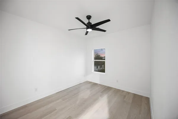a view of a ceiling fan with wooden floor