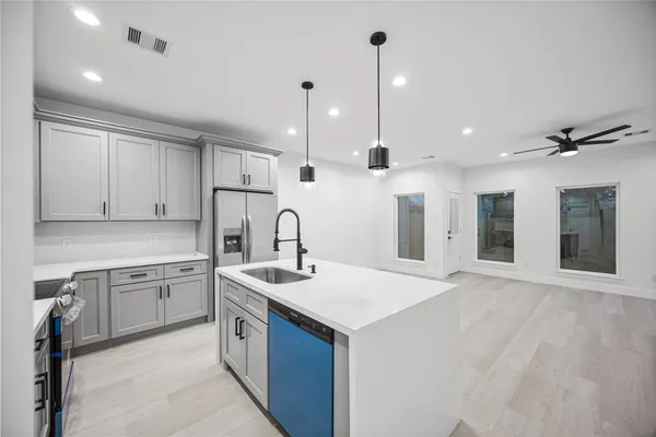 a kitchen with a sink window and cabinets