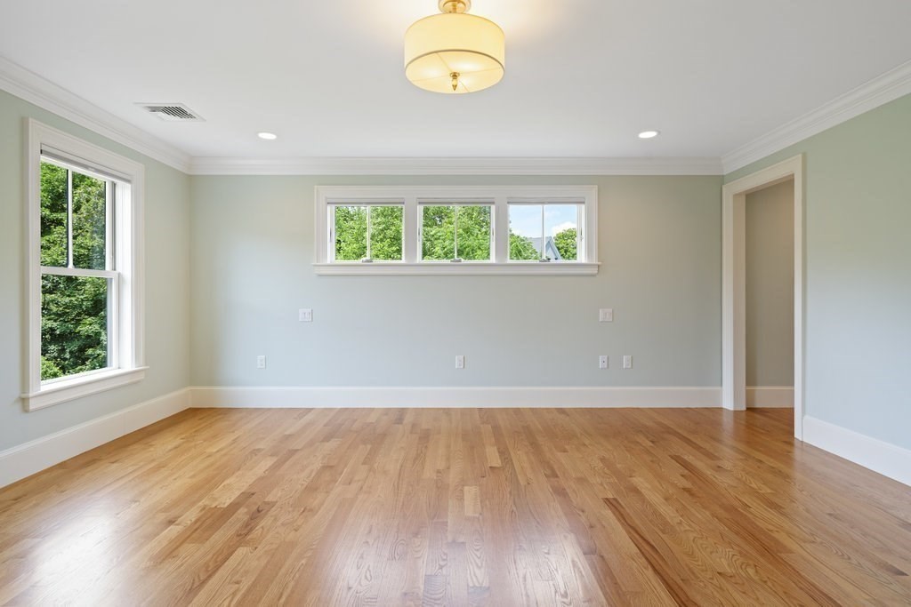 279 Emerson Road Lexington, MA 02420 - Photo 14 of 29 an empty room with wooden floor and windows