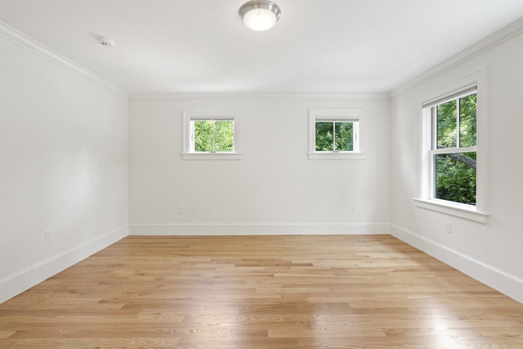 279 Emerson Road Lexington, MA 02420 - Photo 18 of 29 wooden floor in an empty room with a window