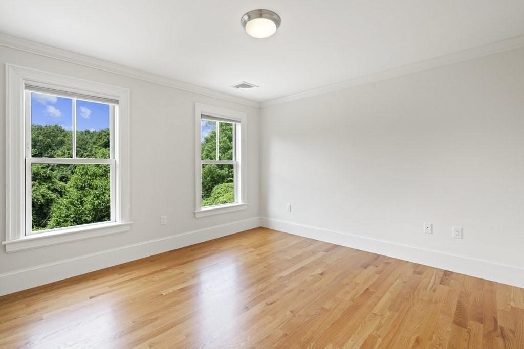 279 Emerson Road Lexington, MA 02420 - Photo 26 of 29 an empty room with wooden floor and windows