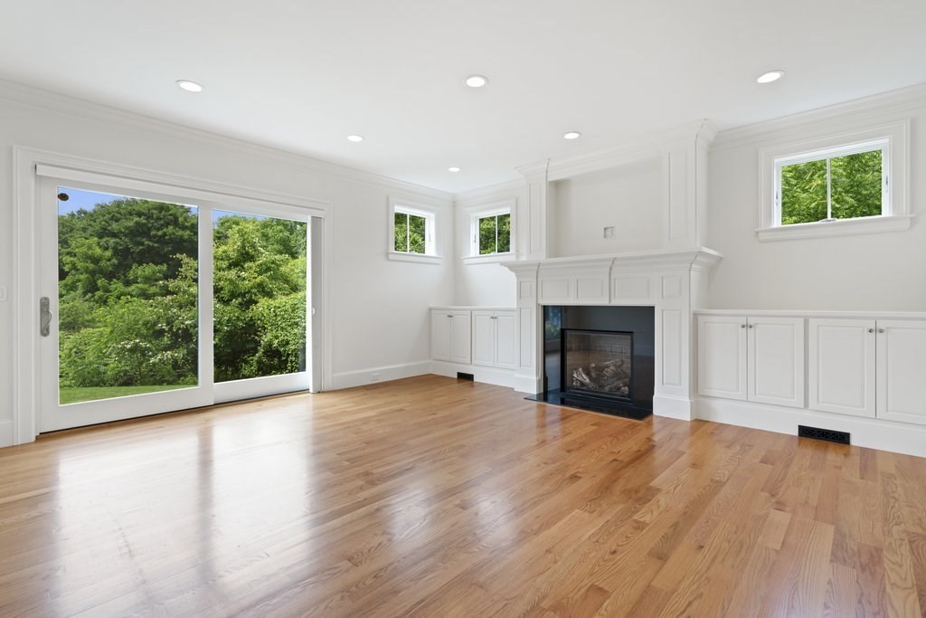 279 Emerson Road Lexington, MA 02420 - Photo 9 of 29 a view of empty room with wooden floor and fireplace