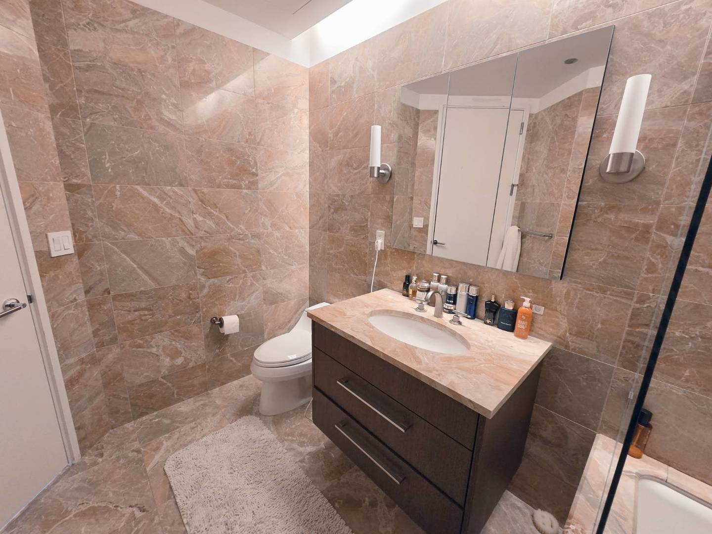 401 North Wabash Avenue, Unit 79C Chicago, IL 60611 - Photo 11 of 38 a bathroom with a sink a toilet and shower