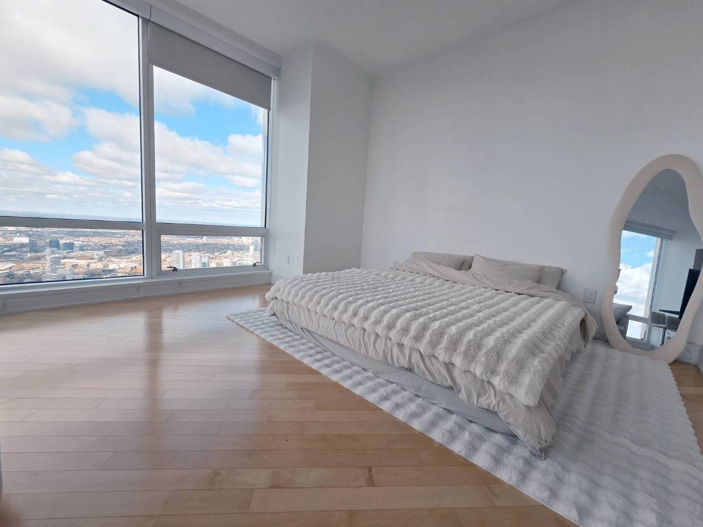 401 North Wabash Avenue, Unit 79C Chicago, IL 60611 - Photo 5 of 38 a bedroom with a bed and glass walk in closet