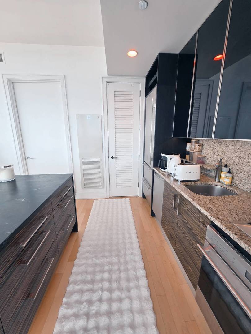 401 North Wabash Avenue, Unit 79C Chicago, IL 60611 - Photo 6 of 38 a spacious bathroom with a granite countertop double vanity sink a mirror and shower