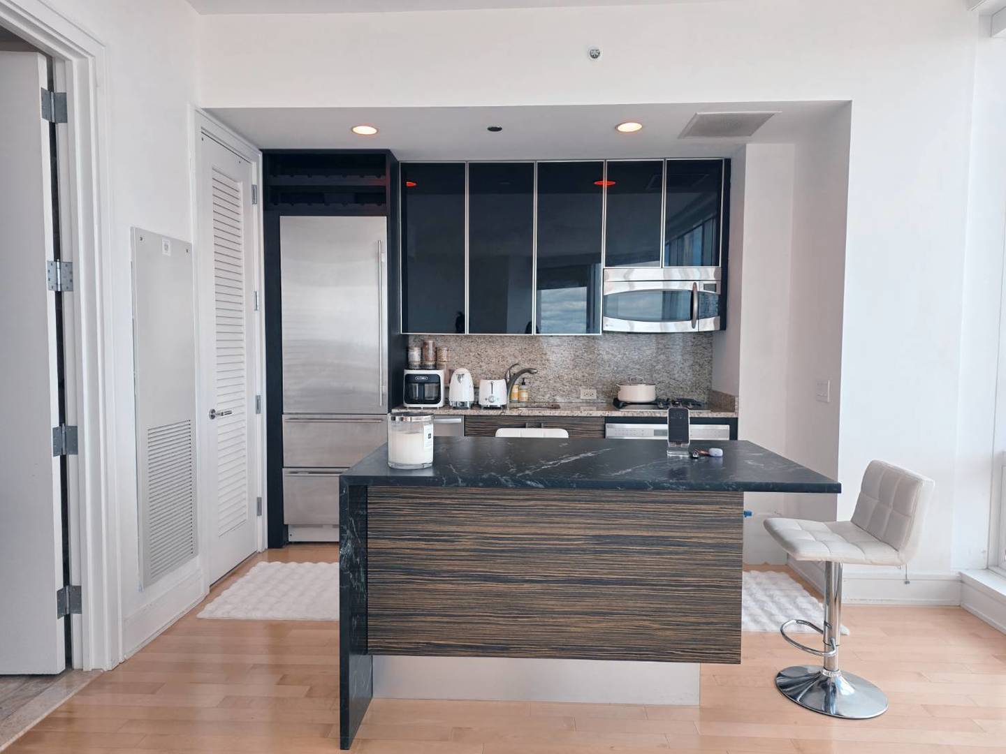 401 North Wabash Avenue, Unit 79C Chicago, IL 60611 - Photo 8 of 38 a view of living room with granite countertop furniture and front door