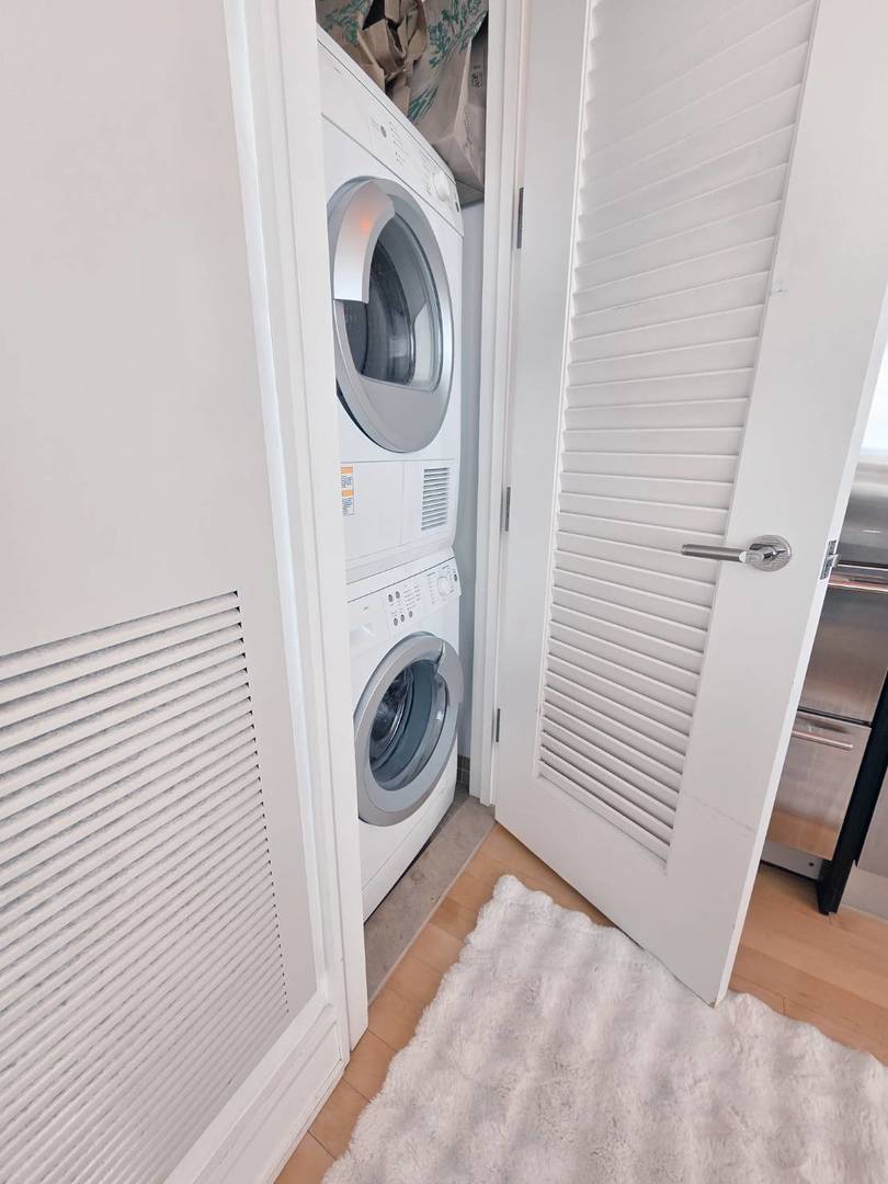 401 North Wabash Avenue, Unit 79C Chicago, IL 60611 - Photo 9 of 38 a view of a hallway with washer and dryer