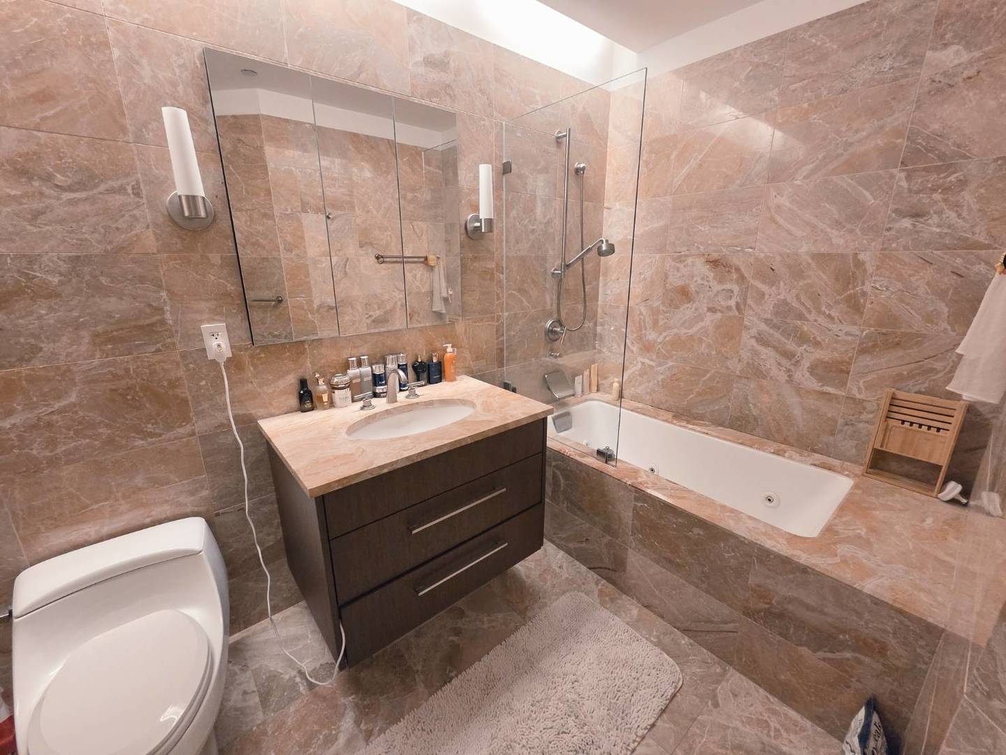 401 North Wabash Avenue, Unit 79C Chicago, IL 60611 - Photo 10 of 38 a bathroom with a sink a toilet and shower