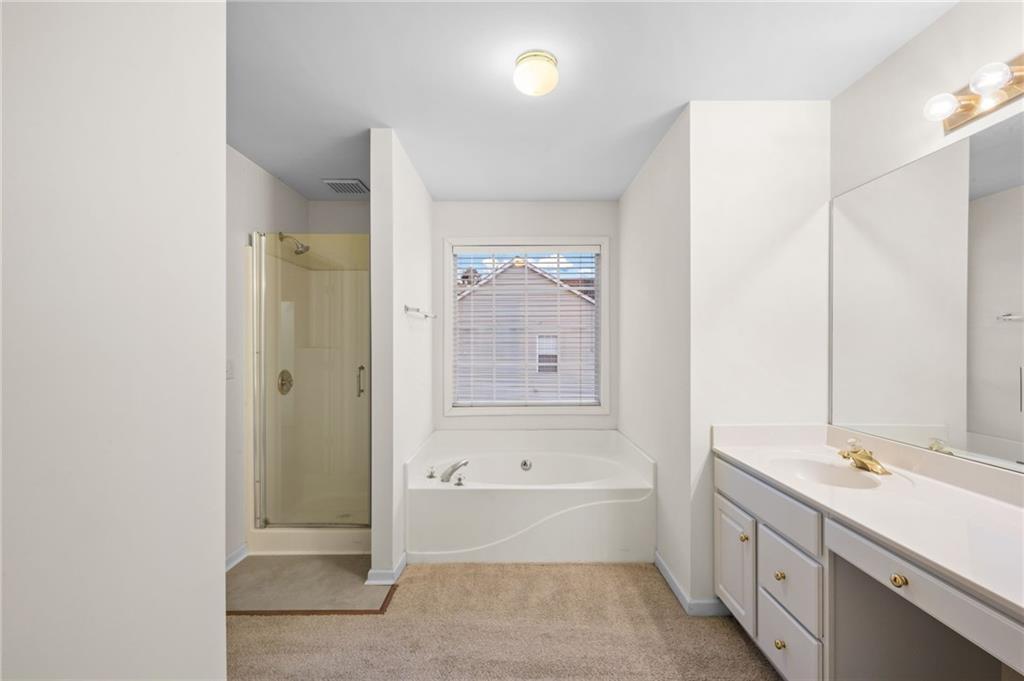 2935 Haynes Club Circle Southwest Grayson, GA 30017 - Photo 13 of 19 a bathroom with a tub sink and mirror