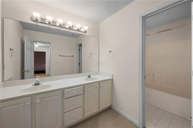 a bathroom with a double vanity sink and a mirror