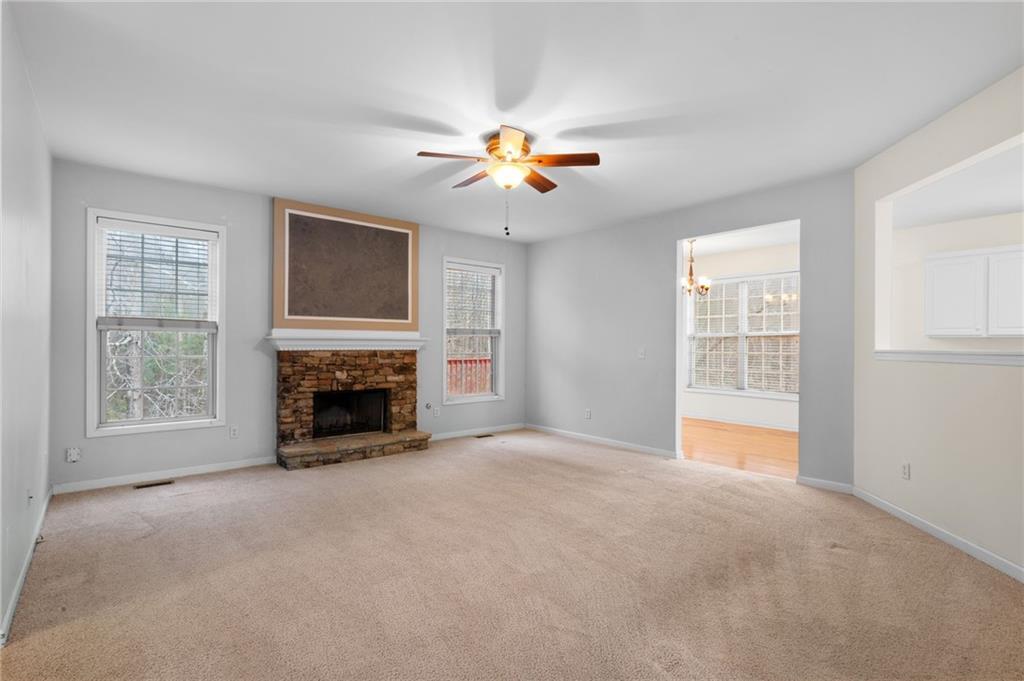 2935 Haynes Club Circle Southwest Grayson, GA 30017 - Photo 7 of 19 a view of livingroom with fireplace fan and a window