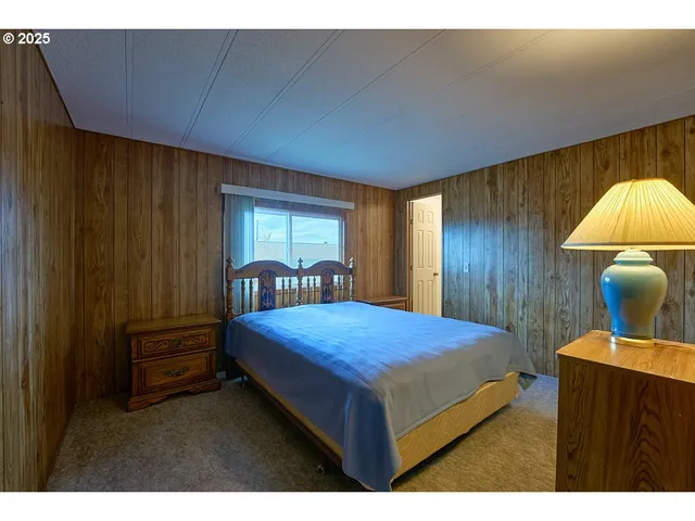 a bedroom with a bed and a mirror