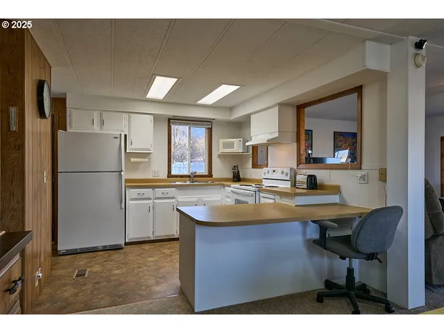 a kitchen with refrigerator and cabinets
