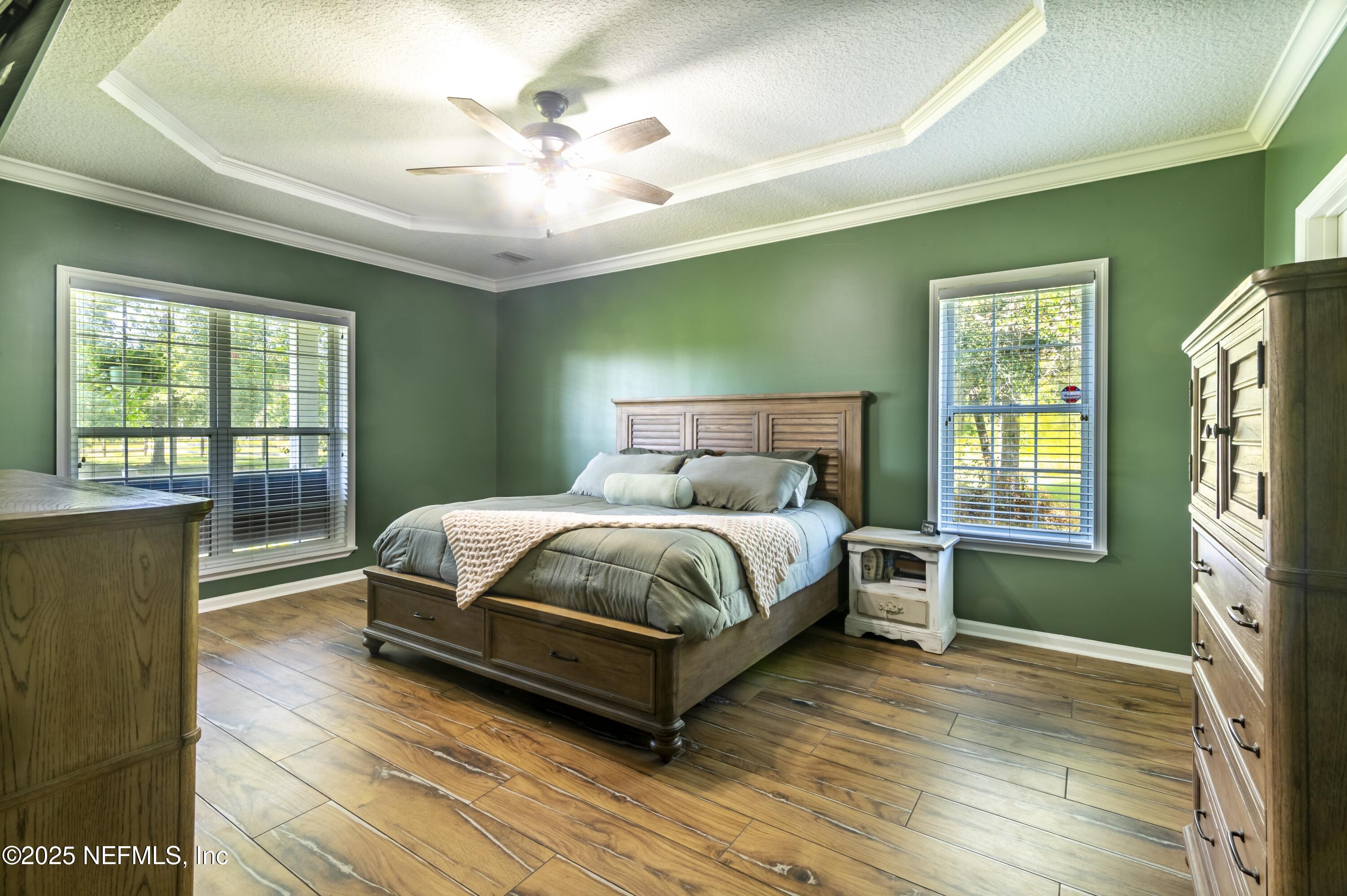 13561 Arnold Rhoden Road Glen St. Mary, FL 32040 - Photo 18 of 38 a bed sitting in a spacious bedroom next to a window