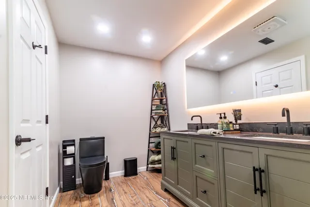 a bathroom with a granite countertop sink mirror and double