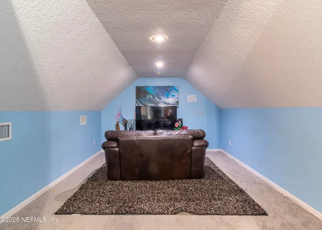 a bedroom with furniture and a dresser