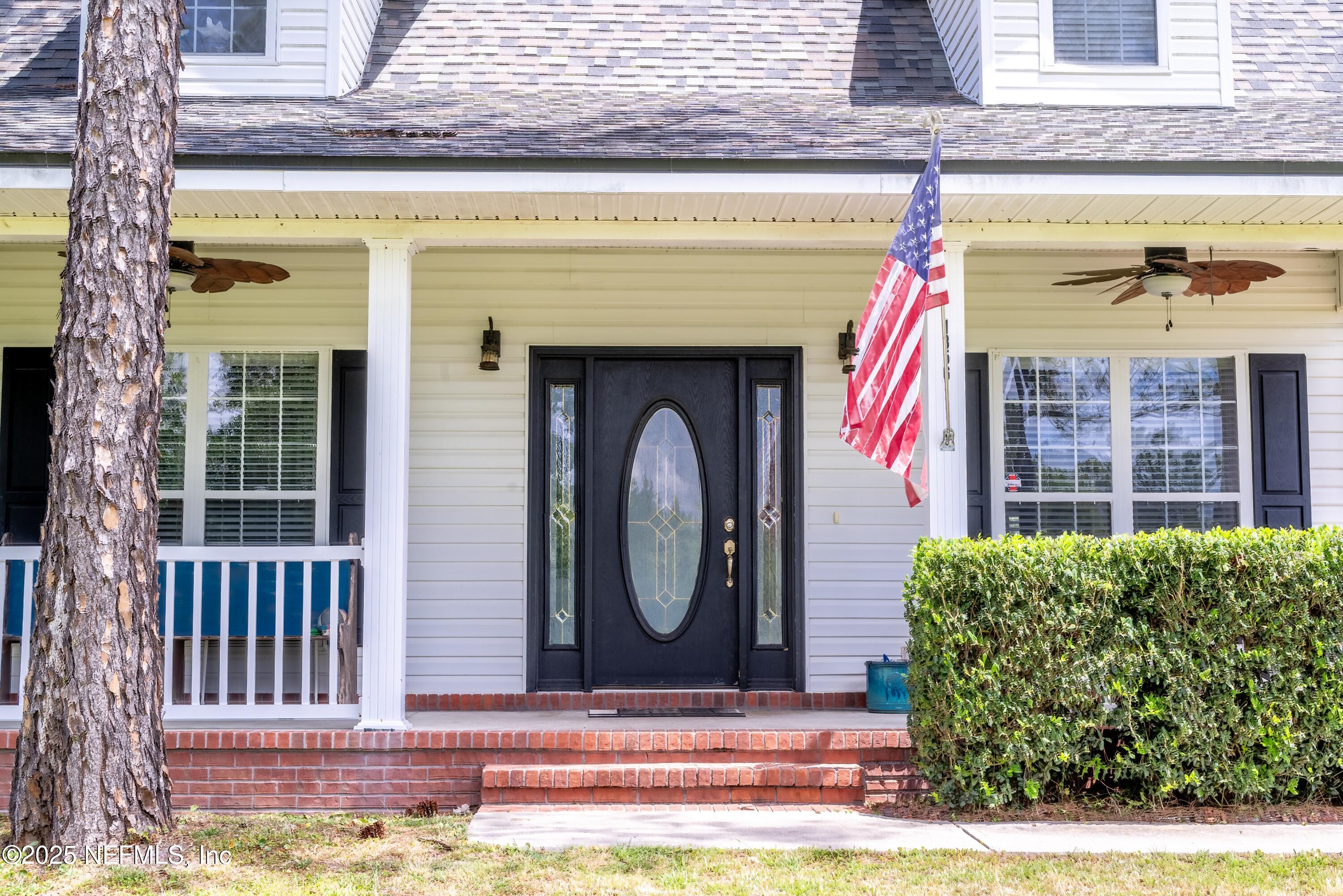 13561 Arnold Rhoden Road Glen St. Mary, FL 32040 - Photo 5 of 38 a front view of a house with garden