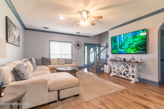 a living room with furniture and a flat screen tv