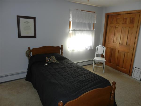 25 Sagamore Road West Springfield, MA 01089 - Photo 21 of 30 a bedroom with a bed and a chair in it