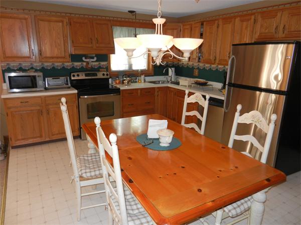 25 Sagamore Road West Springfield, MA 01089 - Photo 5 of 30 a kitchen with stainless steel appliances granite countertop a sink a stove a refrigerator a dining table and chairs