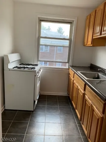 a kitchen with a stove a sink and a microwave