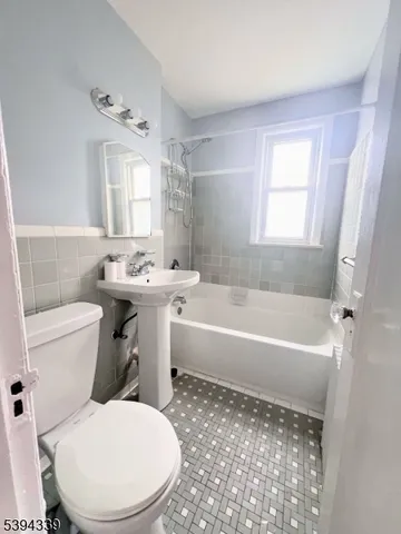 a bathroom with a sink toilet bathtub and vanity