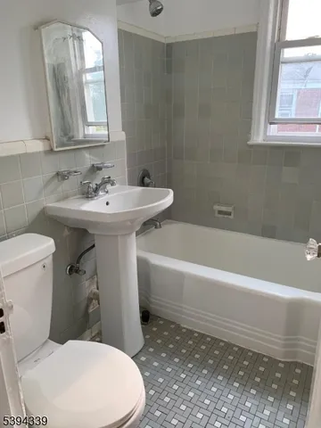 a bathroom with a sink a toilet and bathtub