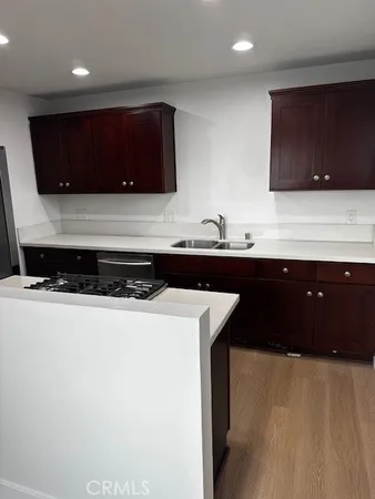 a kitchen with stainless steel appliances a sink and a microwave
