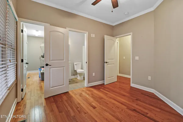 a view of empty room with wooden floor
