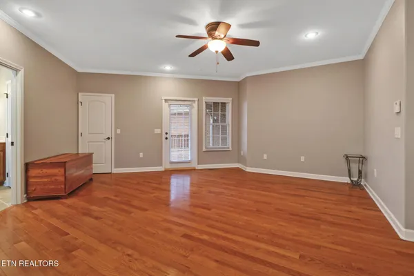 a view of empty room with wooden floor