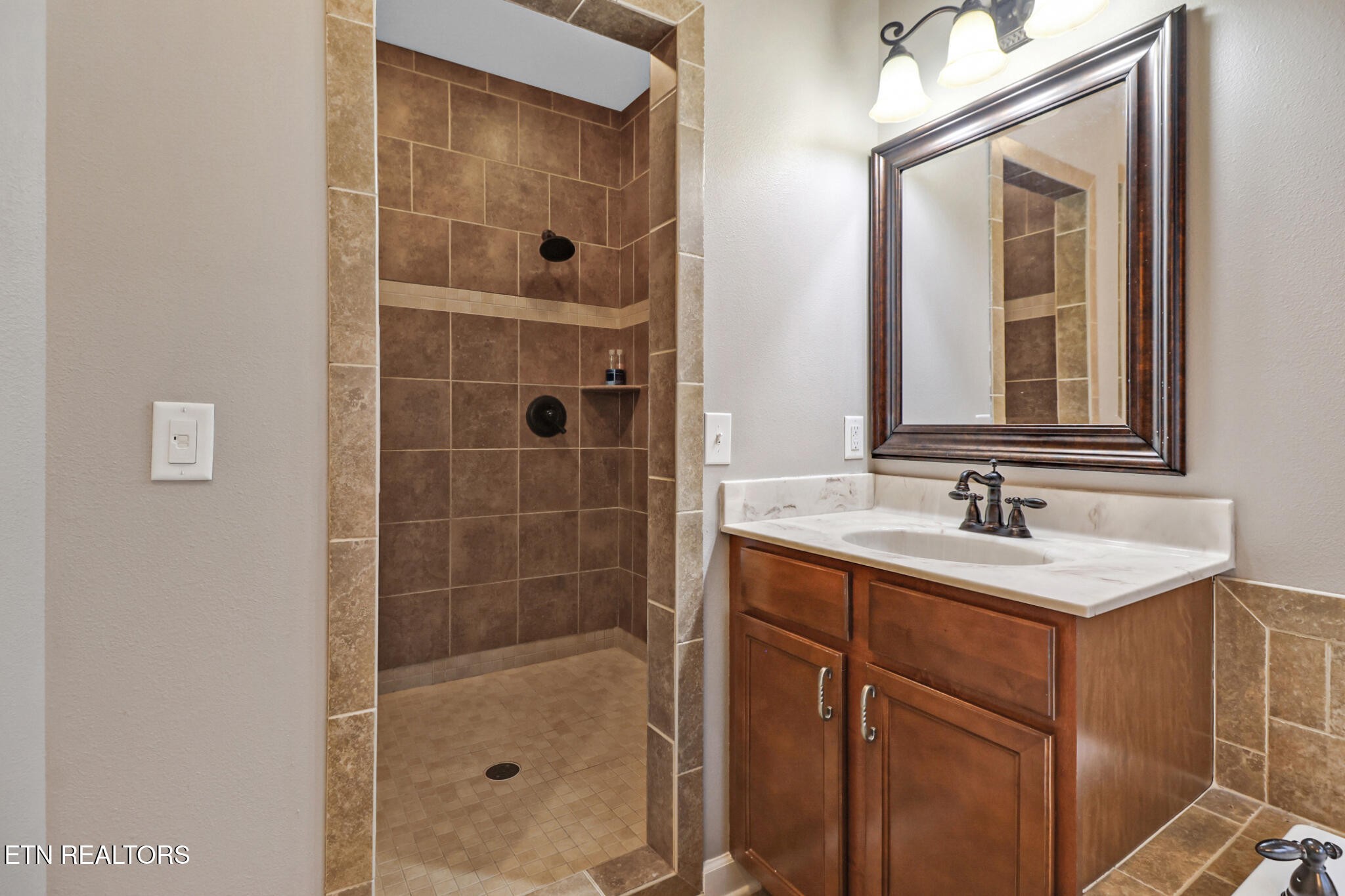 5424 Wilder Road Grimsley, TN 38565 - Photo 19 of 59 a bathroom with a shower sink and mirror