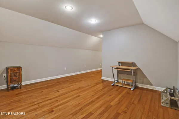 a view of room with stairs and wooden floor