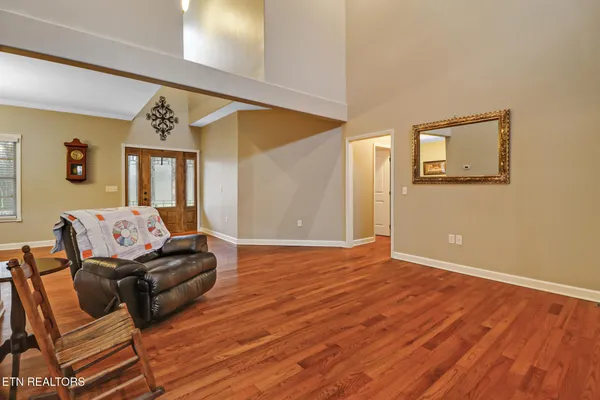 a bathroom with a toilet sink vanity tub and mirror