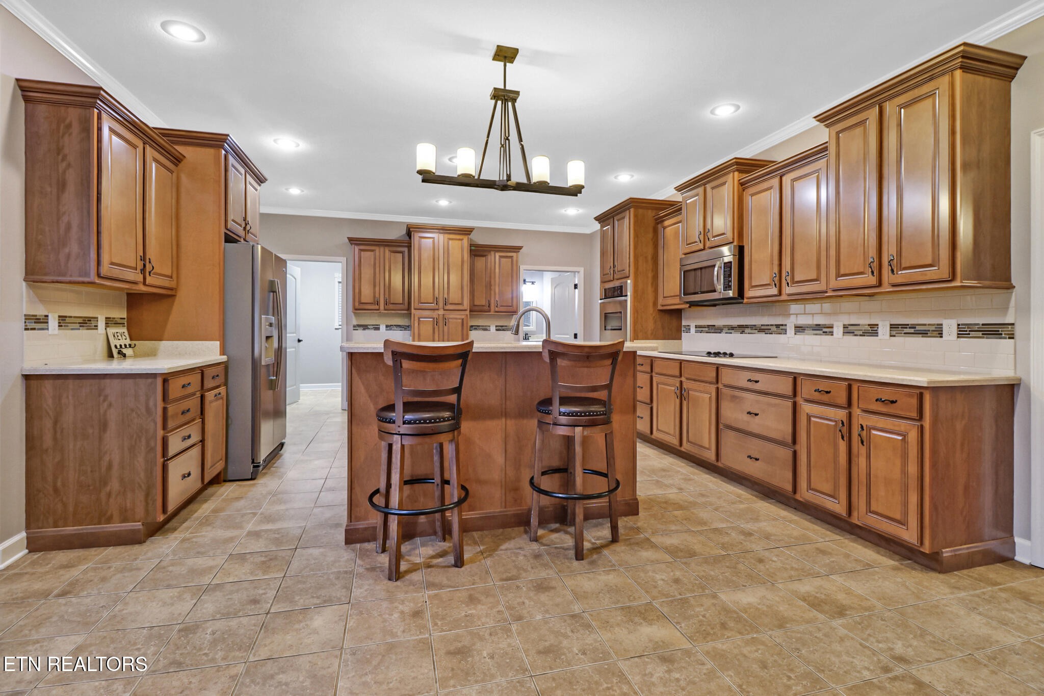 5424 Wilder Road Grimsley, TN 38565 - Photo 33 of 59 a large kitchen with cabinets chairs and refrigerator