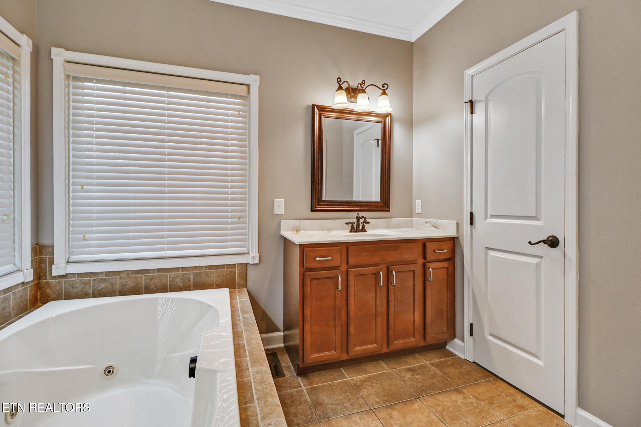 5424 Wilder Road Grimsley, TN 38565 - Photo 34 of 59 a bathroom with a tub sink and mirror