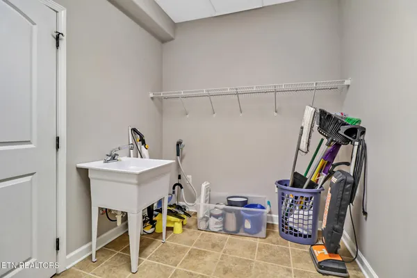 a kitchen with stainless steel appliances a sink a stove a refrigerator cabinets and a kitchen island