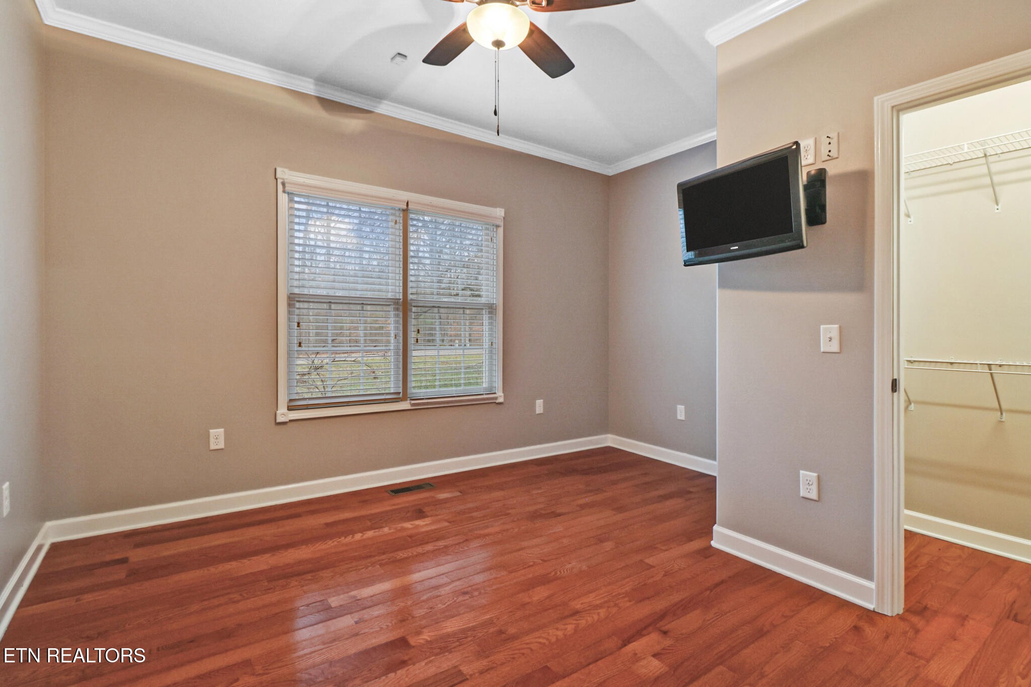 5424 Wilder Road Grimsley, TN 38565 - Photo 41 of 59 an empty room with wooden floor flat screen tv and windows