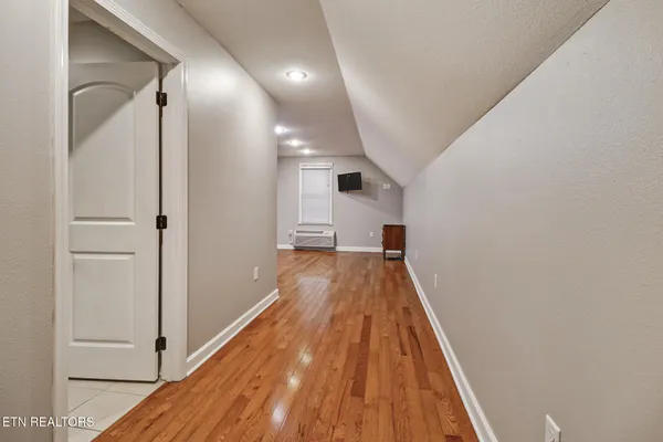 a living room with furniture gym equipment and a window