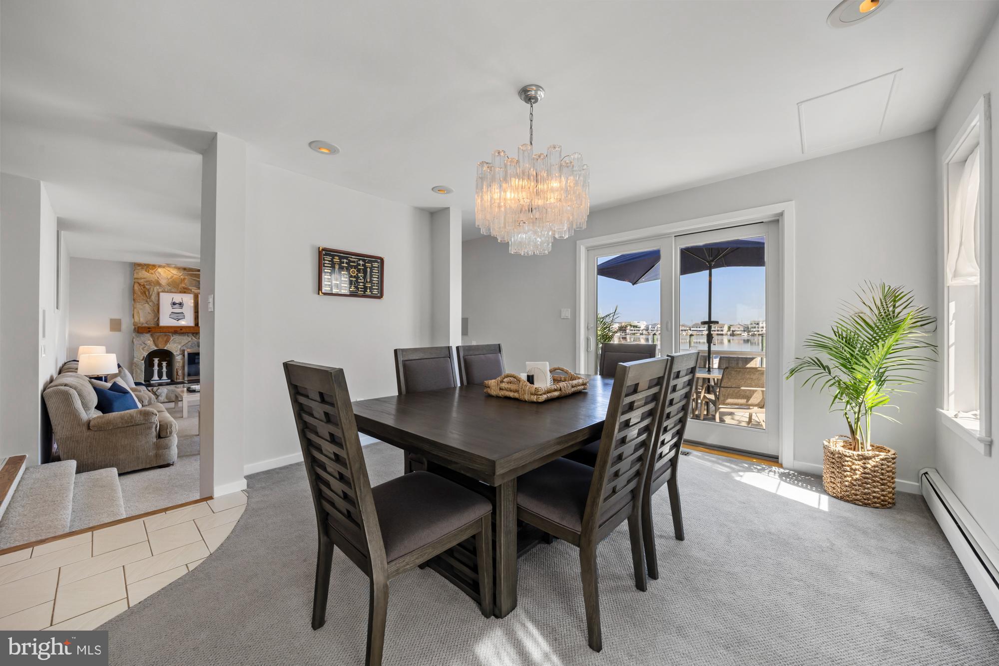 87 Lagoon Boulevard Brigantine, NJ 08203 - Photo 13 of 66 a view of a dining room with furniture and chandelier